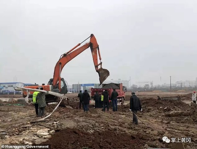 A picture released by the Huanggang government shows construction workers installing necessary facilities on the site of Dabie Mountain Regional Medical Centre on January 25