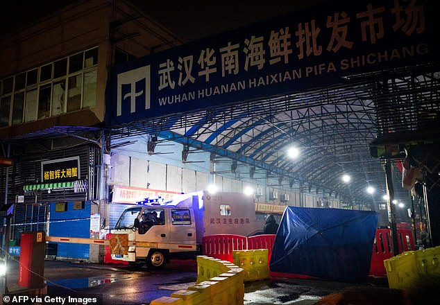 members of staff of the Wuhan Hygiene Emergency Response Team drive their vehicle as they leave the closed Huanan Seafood Wholesale Market in the city of Wuhan, in Hubei on January 11