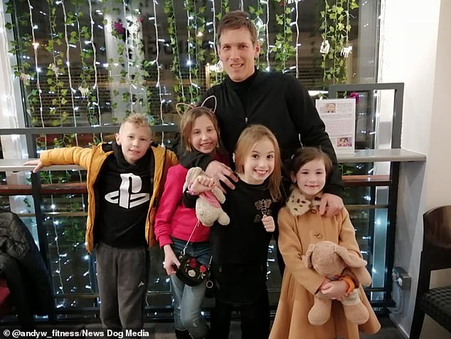 Andy pictured with four of his seven grandchildren. The personal trainer only weight trains three times per week for no more than an hour